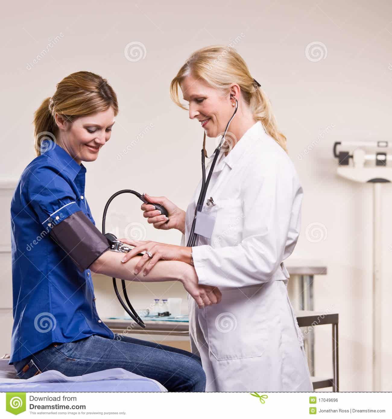 Doctor Checking Woman Blood Pressure Stock Photo