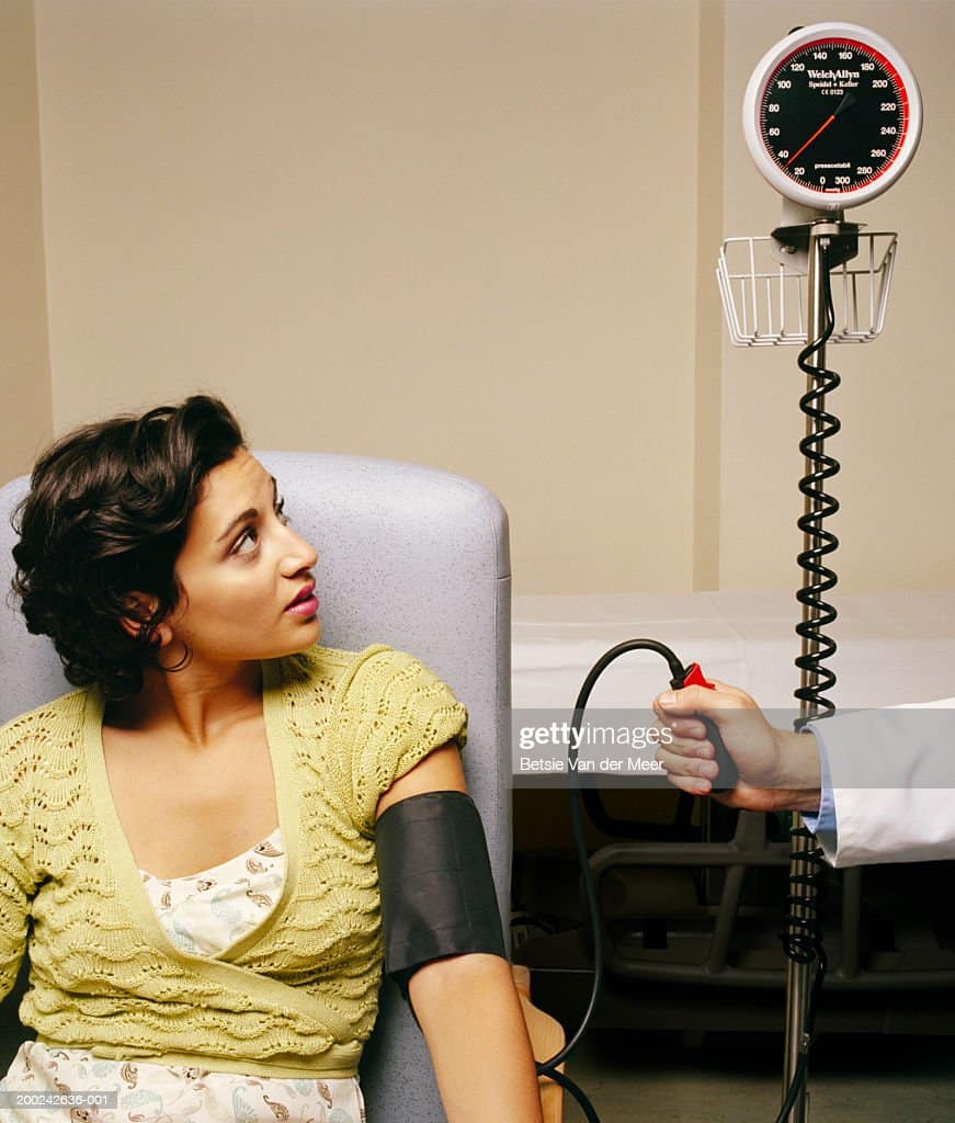 Young Woman Having Blood Pressure Taken Stock Photo